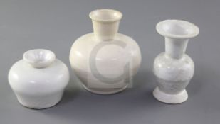 A Chinese Dehua white glazed bottle and two Dehua white glazed vases, Yuan-Ming dynasty, the Yuan