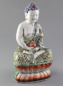 A Chinese enamelled porcelain seated figure of Buddha Shakyamuni, late 19th century, holding a jewel