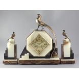 A 1930's onyx and hard stone mantel clock garniture, the octagonal case surmounted by a stylised