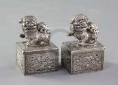 A pair of late 19th/early 20th century Chinese Export silver incense boxes, each with sliding lid