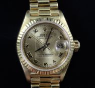 A lady's 18ct gold Rolex Oyster Perpetual wrist watch, with yellow Roman dial and date aperture,