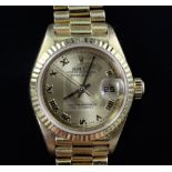 A lady's 18ct gold Rolex Oyster Perpetual wrist watch, with yellow Roman dial and date aperture,