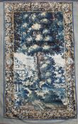 An early 17th century Brussels verdure tapestry, depicting a tree in a landscape within flower and