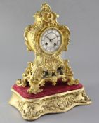 A mid 19th century French ormolu mantel clock and stand, the cartouche case raised on a giltwood