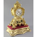 A mid 19th century French ormolu mantel clock and stand, the cartouche case raised on a giltwood