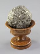 A Teklite nodule, diameter 2.5in., with wooden stand