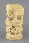 An Indian or Burmese ivory figure of an elephant, late 19th century, standing on an oval pedestal