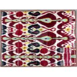 An 1880-1900 Uzbekistan hand-woven and dyed Ikat, designed in white, red, green, purple, yellow