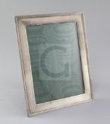 A George V engine turned silver mounted photograph frame by Asprey & Co, of rectangular form, with