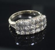 An 18ct gold triple row diamond ring, set with twenty one old round cut stones, size O.