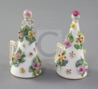 A pair of Meissen floral encrusted candle extinguishers, 19th century, underglaze blue cross sword