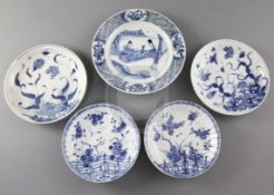 Four Chinese blue and white saucer dishes, and a similar plate, Kangxi period, the saucers painted