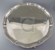 A large Edwardian silver salver by Elkington & Co, of shaped circular form, with gadrooned border,