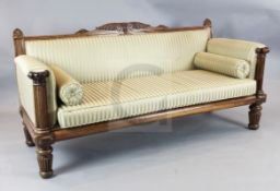 A William IV carved rosewood settee, decorated with acanthus scroll and palmette motifs, W.6ft