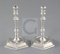 A pair of George V 19th century style cast silver tapersticks by Thomas Bradbury & Sons,