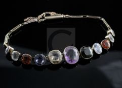 An early 20th century gold and multi gem bracelet, set with assorted graduated stones including