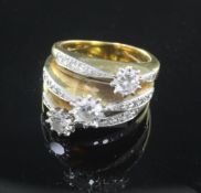 An 18ct gold and diamond triple band dress ring, each band set with a single raised claw set round