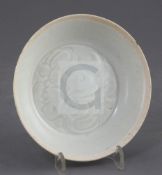 A Chinese Qingbai dish, early Song dynasty, the interior incised with scrolling foliage, unglazed