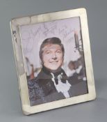 Liberace: An autographed colour photograph of Liberace, inscribed 'Liberace with a candelabra upon a