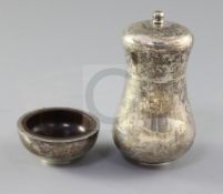 A late 1970's silver baluster pepper mill and a silver mounted hardwood salt, by Simon J. Beer (