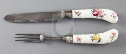 A Meissen porcelain handled knife and fork, c.1750, painted with floral sprays, ozier moulded