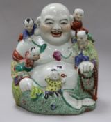 A Chinese enamelled porcelain figure of Budai with attendants height 30cm