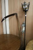 A scythe and two metal lamps