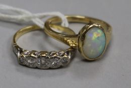 An 18ct gold and graduated five stone diamond ring and a 9ct gold and white opal ring.