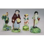 A Staffordshire figure of a gardener by Walton. And three other figures. Height: 16cm