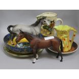 A group of assorted ceramics including two Beswick horses, a Doulton anglers jug and a Poole dish