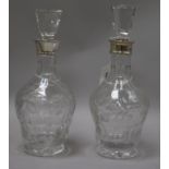 A pair of silver collared cut glass decanters, 29cm