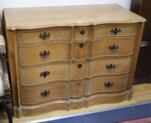 A pair of serpentine pine commodes of three short and three long drawers W.114cm