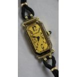 A lady's 18ct gold Longines manual wind wrist watch retailed by Tiffany & Co, on fabric strap.