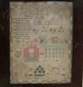 An early 19th century needlework sampler with alphabet, houses, lion, flowers and other motifs,