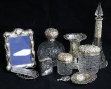 Five silver mounted glass toilet jars, three other silver items and a plated photograph frame.