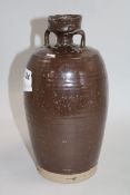 A Chinese late Ming brown glazed spouted jar