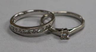 A modern 18ct white gold and diamond set half eternity ring and a 9ct white gold and solitaire
