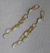 A pair of 14ct gold and white opal drop earrings, 49mm.