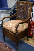 A Victorian caned beech commode chair