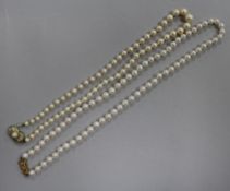 A single strand cultured pearl necklace with gold clasp and a simulated pearl necklace.