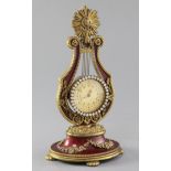 A French enamelled gilt metal lyre shaped timepiece, 22cm