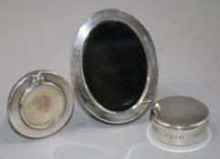 A small Tiffany silver pill box and two small photograph frames.From the estate of the late Sheila