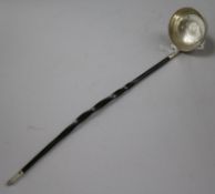 An 18th century white metal toddy ladle, with inset coin bowl and baleen handle, 36.6cm.