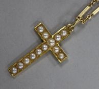 A 15ct yellow gold cross set with seed pearls on 14ct yellow gold chain.