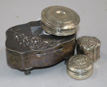 An Edwardian silver trinket box, a Dutch silver pill box and two other silver pill boxes.