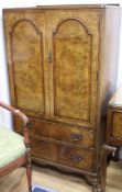 A small walnut gentleman's cupboard, fitted two doors over two small drawers W.75cm
