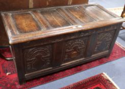 An early 18th century carved oak coffer W.138cm