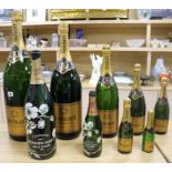 A set of seven graduated Ruinart champagne bottles and two others tallest 67cm
