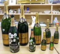 A set of seven graduated Ruinart champagne bottles and two others tallest 67cm