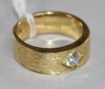 A modern textured 18ct gold and gypsy set single stone diamond ring, gross 13 grams, size R